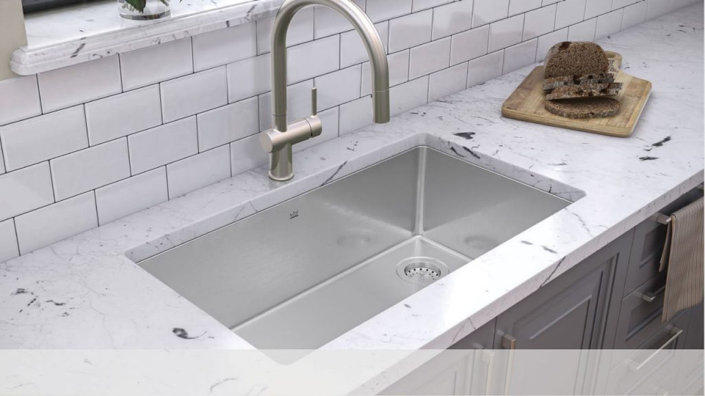 Large single bowl stainless steel Kindred undermount sink in a modern kitchen