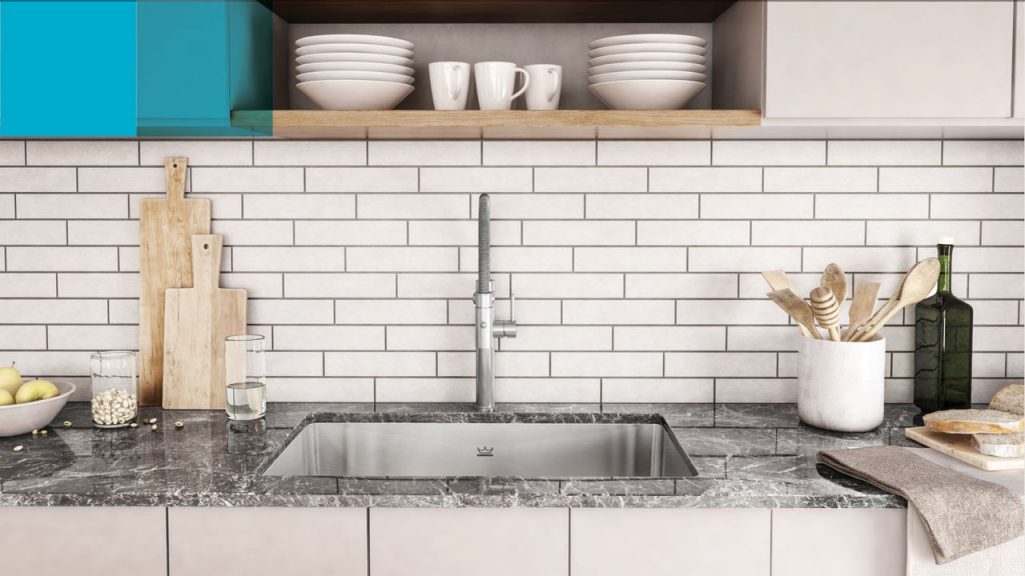 Modern kitchen wtih a single bowl Kindred stainless steel sink with chrome pull down faucet.
